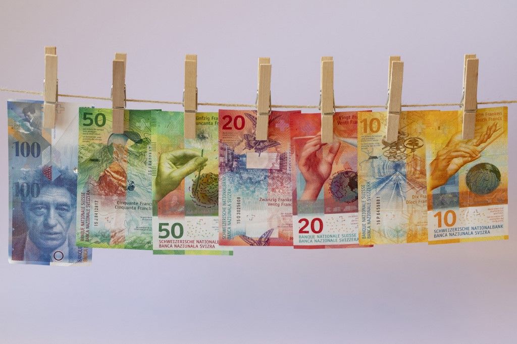 Swiss franc banknotes on a washing line | usage worldwide (Photo by Robert Schmiegelt/Geisler-Fotopr / Geisler-Fotopress / dpa Picture-Alliance via AFP)