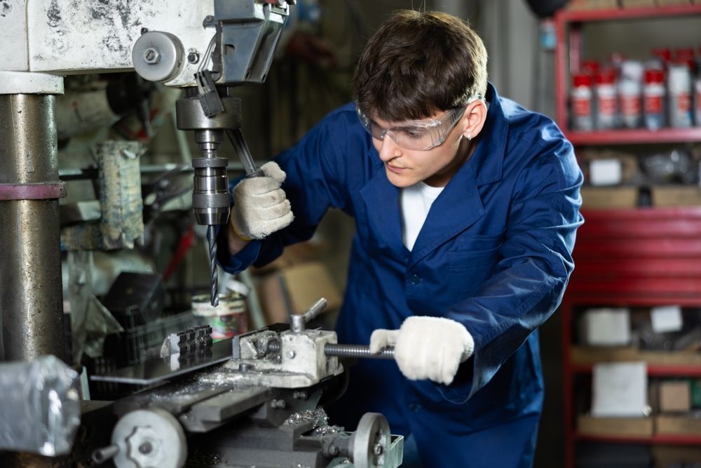 Skilled,Young,Factory,Worker,,béremelés, In,Blue,Work,Coat,,Protective,Glasses