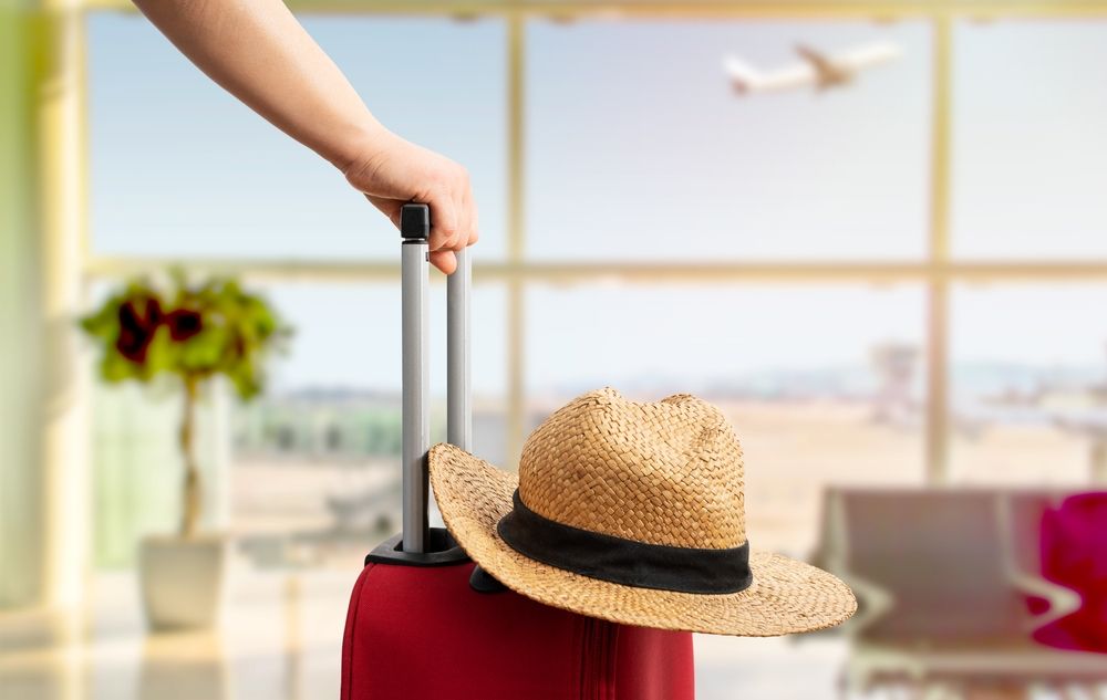 Woman,With,Red,Suitcase,And,Hat,Standing,At,Airport.tourism,Concept
wales