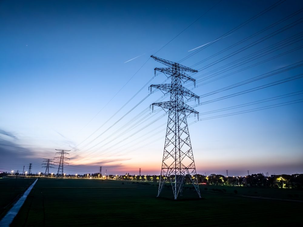 High,Voltage,Electricity,Tower,Landscape,At,Sunset