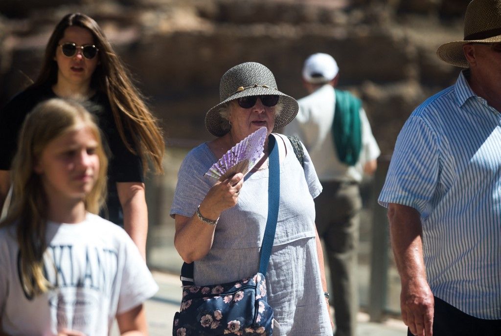 MALAGA, SPAIN - AUGUST 3: An elderly woman wearing a hat to protect herself from the sun uses a fan during a hot summer day in Malaga, Spain on August 3, 2023. Spain is experiencing unusually high temperatures, particularly in the southern region of Andalusia. According to the Spanish State Agency of Meteorology, several cities are expected to exceed 38 degrees Celsius. Jesus Merida / Anadolu Agency (Photo by Jesus Merida / ANADOLU AGENCY / Anadolu via AFP)