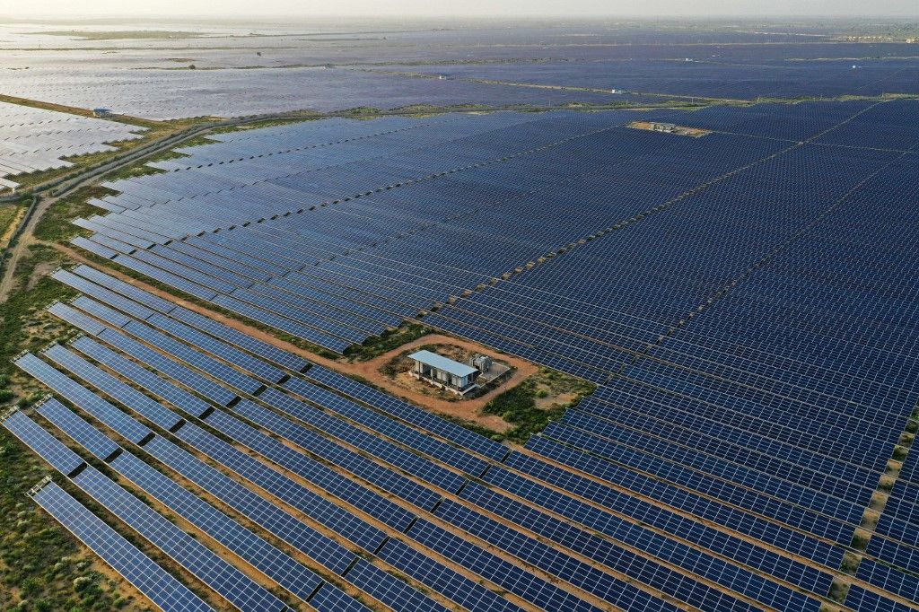 This photo taken on October 6, 2021 shows solar panels at the site of solar energy projects developer Saurya Urja Company of Rajasthan Limited, at the Bhadla Solar Park in Bhadla, in the northern Indian state of Rajasthan. Currently, coal powers 70 percent of the nation's electricity generation, but Indian Prime Minister Narendra Modi pledged on November 1 that it would produce more energy than India's entire grid now through solar and other renewables by 2030. (Photo by Sajjad HUSSAIN / AFP) / TO GO WITH Climate-UN-COP26-energy-solar,FEATURE by Glenda KWEK