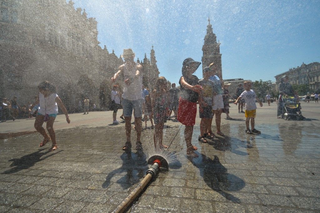 People having fun playing with a water sprinkler in Krakow's Main Square as temperatures reach 37 degrees today. The hit wave that was already lasted two days is set to continue for a week.
A water sprinkers were made available for passers-by around Krakow. 
On Tuesday, August 1st, 2017, in Krakow, Poland. (Photo by Artur Widak/NurPhoto) (Photo by Artur Widak / NurPhoto / NurPhoto via AFP)