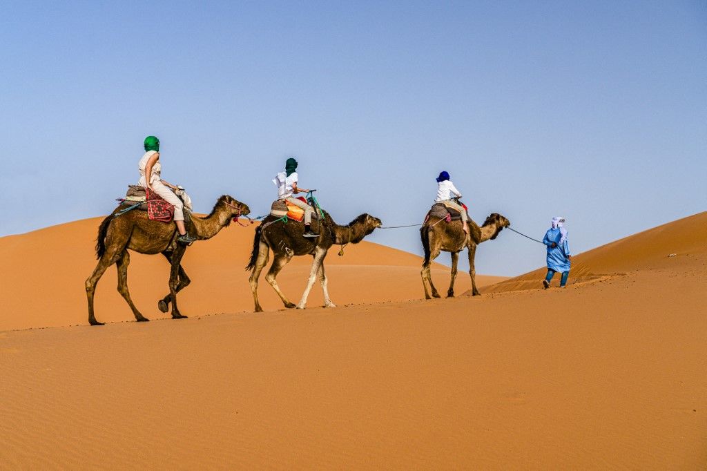 Family with one child enjoying a camel ride in the desert, Erg Chebbi, Merzouga, Sahara Desert, Morocco, North Africa, Africa