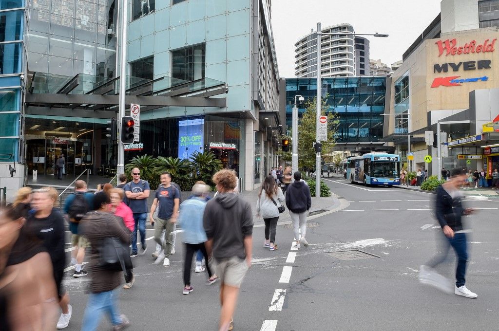 People walk past the Bondi Junction Westfield Shopping Centre in Sydney on April 19, 2024, nearly a week after a stabbing incident at the mall. (Photo by Ayush Kumar / AFP)