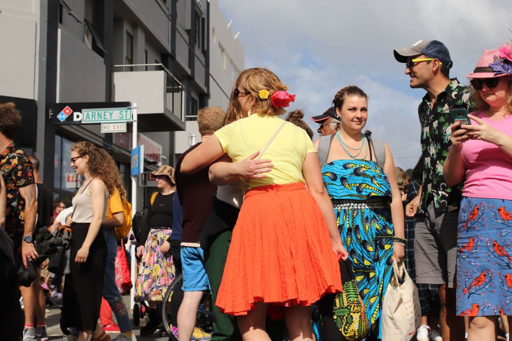 WELLINGTON, NEW ZEALAND - APRIL 11: Young people hug their friends in the street at the Newtown Festival on April 11, 2021 in Wellington, New Zealand. 