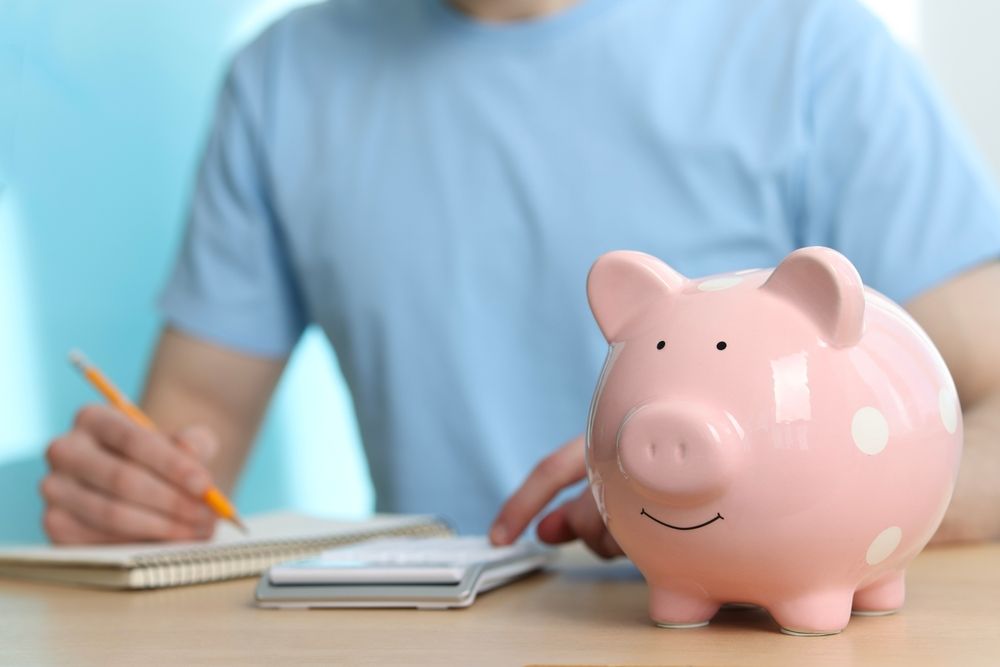 Financial,Savings.,Man,Writing,Down,Notes,At,Wooden,Table,,Focus, bank