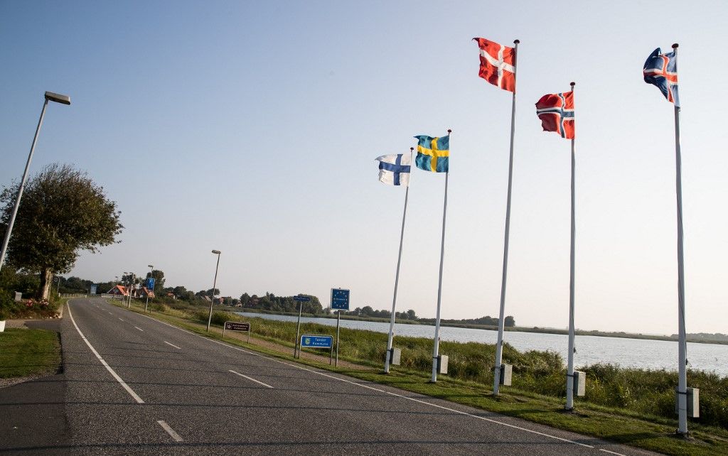 The border between Germany and Denmark, at the border crossing betwen Rudbol in Denmark and Rosenkranz, Germany, 14 September 2016. The flags of Finland, Sweden, Denmark, Norway and Iceland fly from the poles. 
PHOTO: CHRISTIAN CHARISIUS/DPA (Photo by CHRISTIAN CHARISIUS / DPA / dpa Picture-Alliance via AFP)