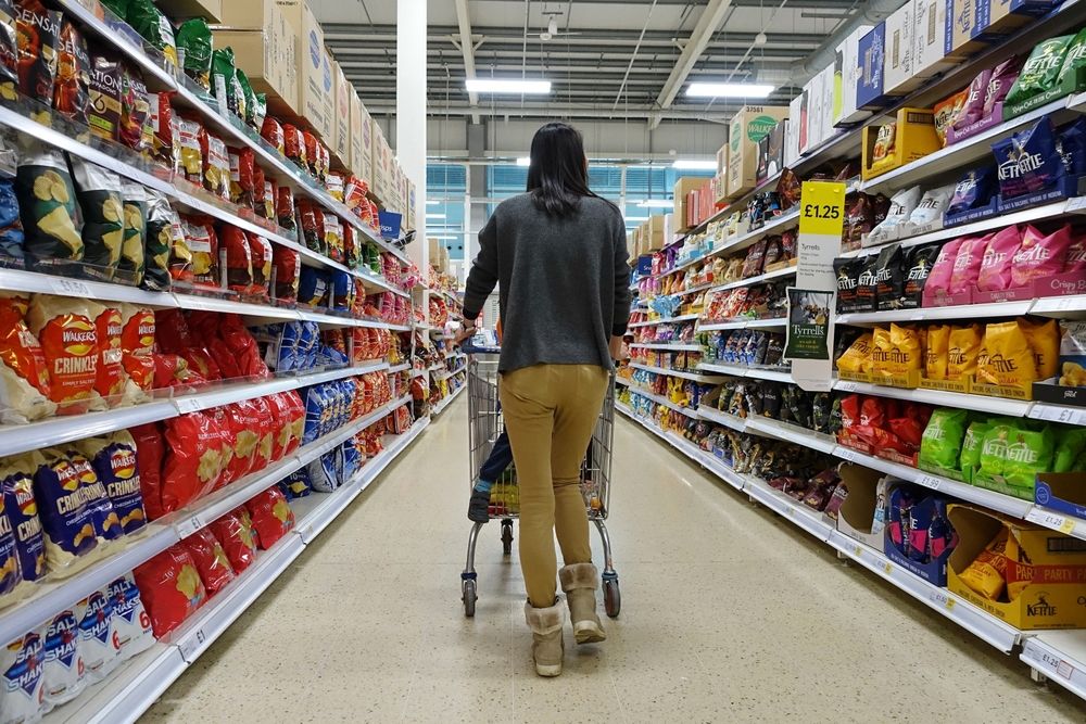 Shoppers,Browse,An,Aisle,In,A,Tesco,Supermarket,On,April