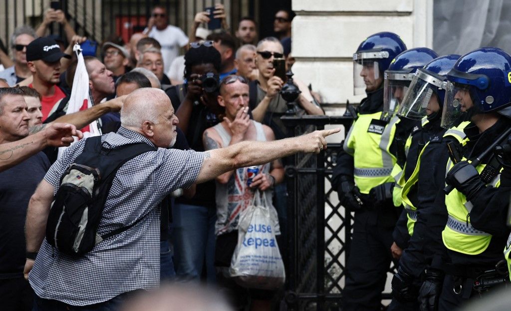 Protestors remonstrate with Police officers during the 'Enough is Enough' demonstration on Whitehall, outside the entrance to 10 Downing Street in central London on July 31, 2024, held in reaction the Government's response to the fatal stabbings in Southport on July 29. (Photo by BENJAMIN CREMEL / AFP)