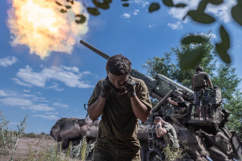 DONETSK OBLAST, UKRAINE - JULY 27: (EDITORS NOTE: The artillery number has been blurred) Ukrainian soldier covers his ears during firing ‘Pion’ artillery at their combat position in Donetsk oblast, Ukraine on July 27, 2024. Diego Herrera Carcedo / Anadolu (Photo by Diego Herrera Carcedo / ANADOLU / Anadolu via AFP)