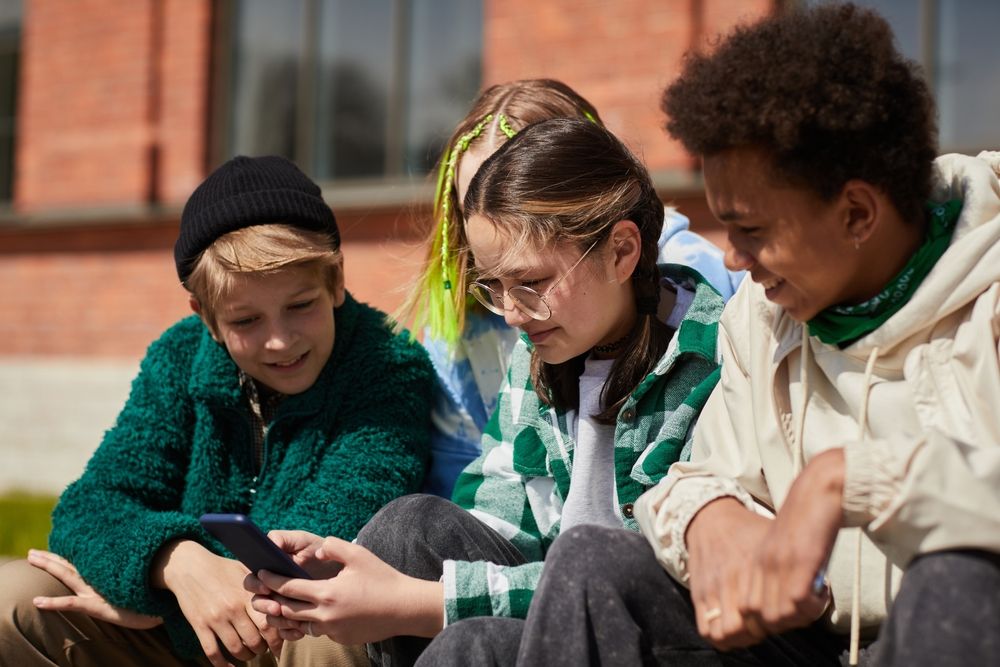 Teenage,Girl,In,Eyeglasses,Communicating,Online,On,Mobile,Phone,While