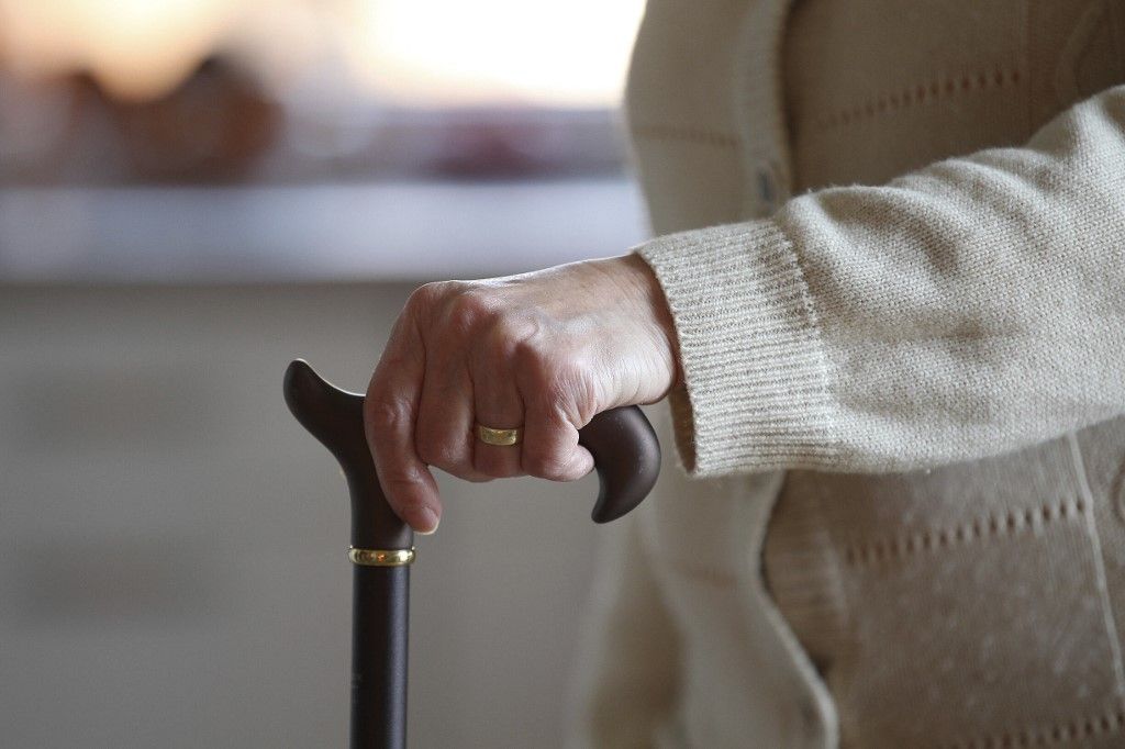 Topic picture - pensioner, senior citizen, elderly woman with rollator, walking aid and walking stick, stick and corona mask, disposable protective mask in old people's home, old people's home, assisted living, idősgondozás