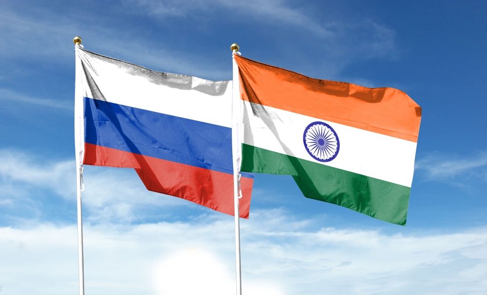 Russian,Flag,And,Indian,Flag,On,Cloudy,Sky.,Waving,In