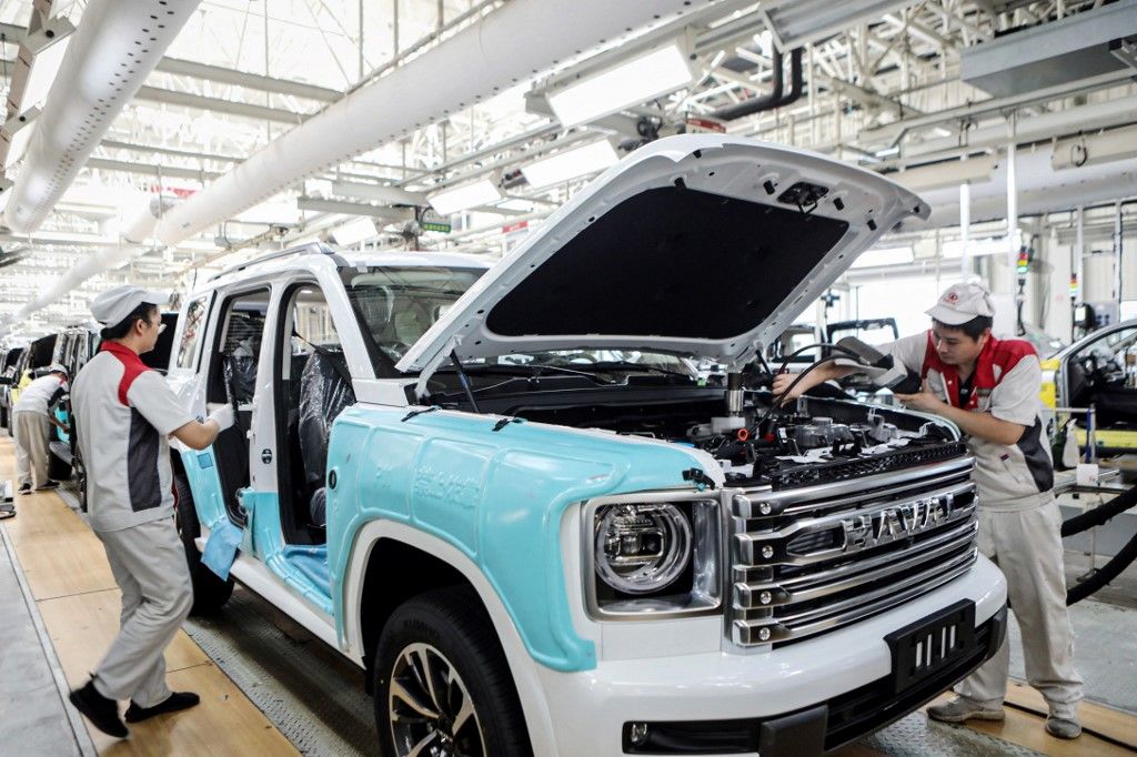 Employees work on a Haval H9 vehicle production line at a factory of the Chinese automobile manufacturer Great Wall Motor in Yongchuan, in southwestern China's Chongqing municipality on September 3, 2024. (Photo by STRINGER / AFP) / China OUT