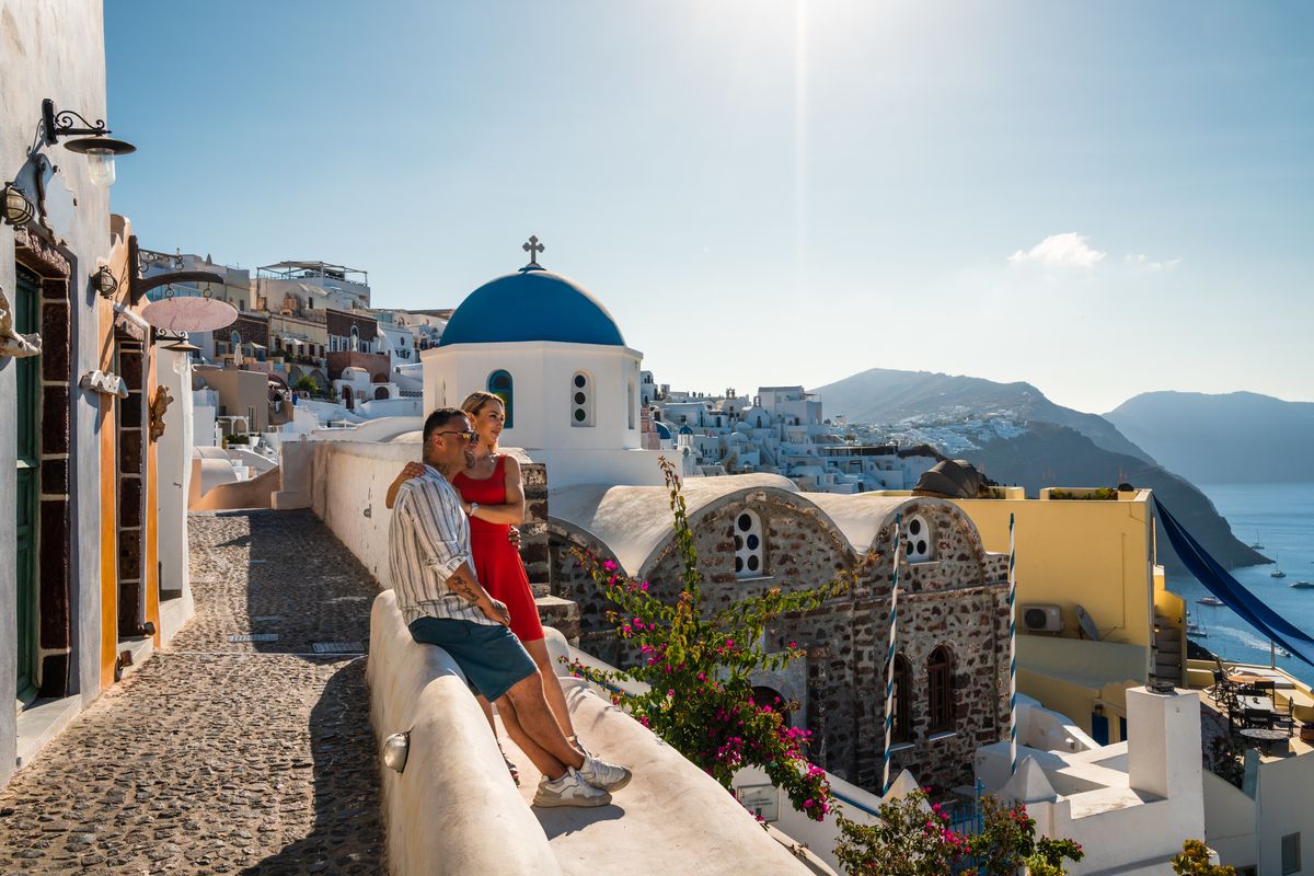 Happy romantic couple in Oia, Santorini, Cyclades islands, Greece