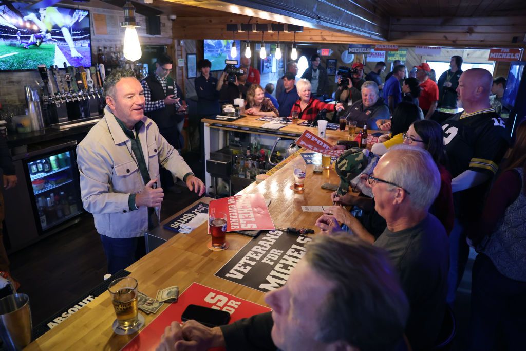 MUSKEGO, WISCONSIN - NOVEMBER 06: Republican gubernatorial candidate Tim Michels greets patrons gathered at Pop's Pub to watch the Green Bay Packers football game on November 6, 2022 in Muskego, Wisconsin. Michels is in a close race with incumbent Democrat Gov. Tony Evers ahead of Tuesday's general election.  (Photo by Scott Olson/Getty Images)