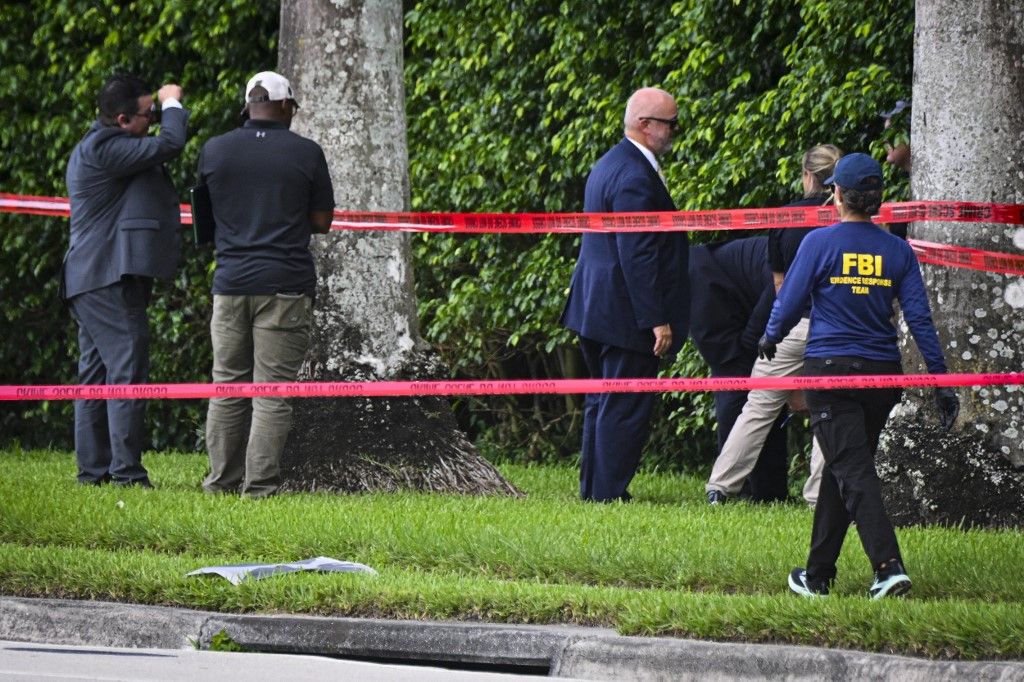 Law enforcement personnel investigate around Trump International Golf Club following an assassination attempt on former President Donald Trump