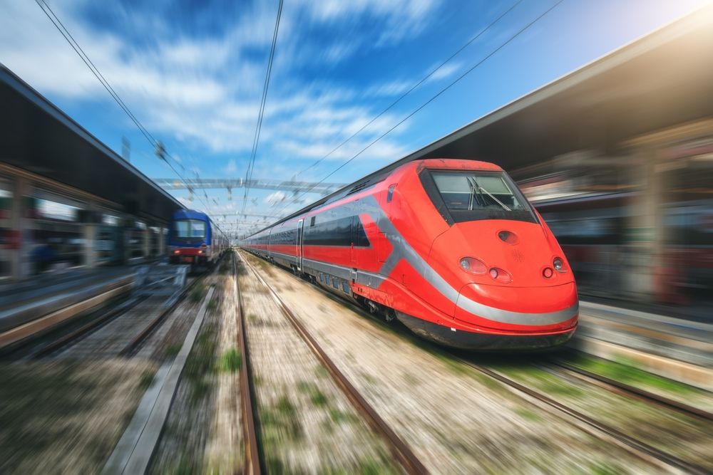 High-speed,Red,Passenger,Train,Moving,At,Railway,Station,Platform,Under