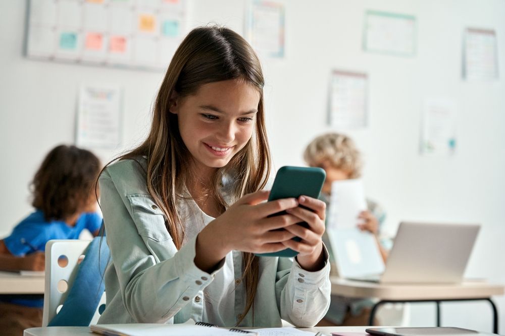 Happy,Latin,Hispanic,Kid,Girl,School,Student,Using,Smartphone,In