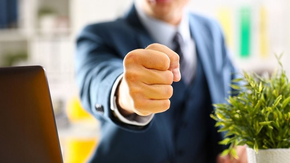 Male,Clenched,Fist,In,Suit,At,Office,Closeup