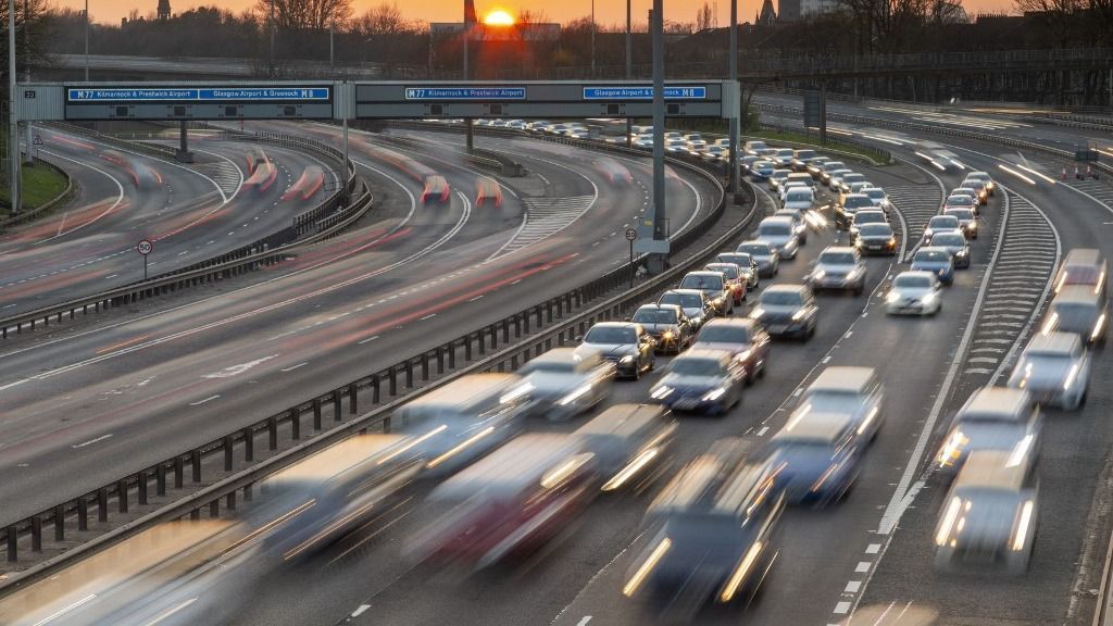 Sunset over M8 motorway traffic, Glasgow, Scotland, United Kingdom, Europe