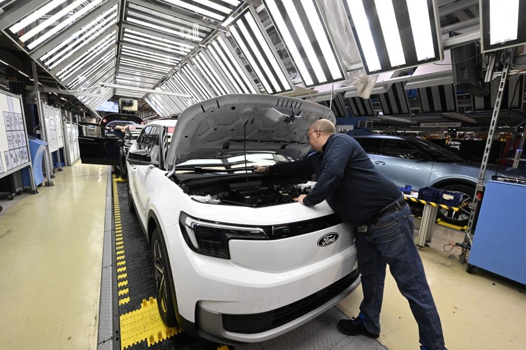 Employees work on the production line of the 100% electric Ford Explorer at the Ford Electric Center Factory in Cologne, western Germany, June 4, 2024. (Photo by Roberto Pfeil / AFP)