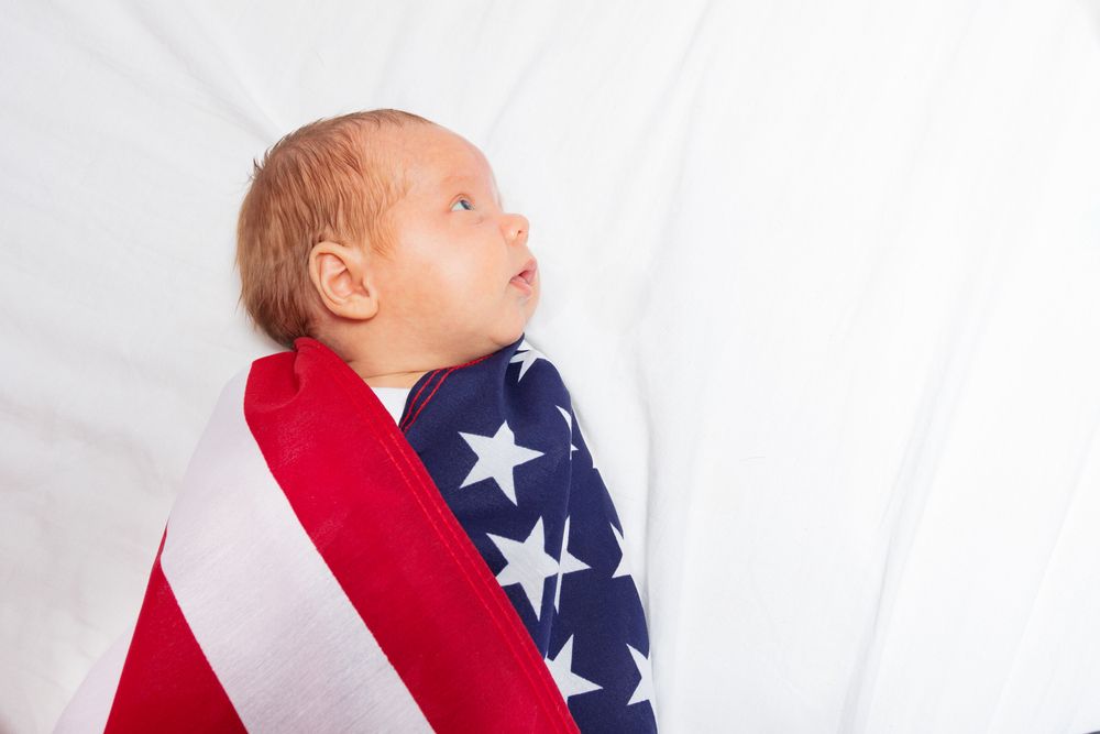 Close,Portrait,Of,Little,Baby,Infant,Boy,Wrapped,In,Usa