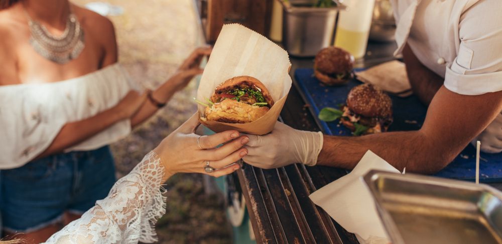 Woman,Hand,Reaching,For,A,Burger,At