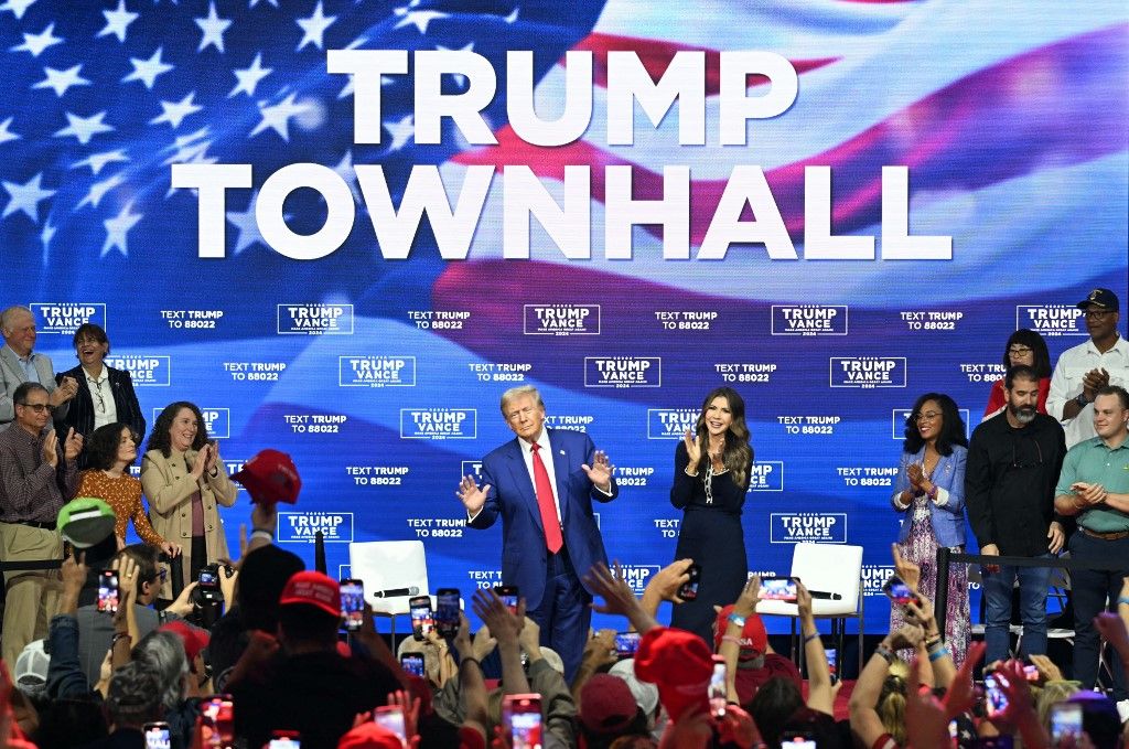 Republican presidential nominee Donald Trump hosts a town hall
Former US President and Republican presidential candidate Donald Trump, with moderator and South Dakota Governor Kristi Noem (R), arrives for a town hall at the Greater Philadelphia Expo Center and Fairgrounds in Oaks, Pennsylvania, on October 14, 2024. (Photo by Jim WATSON / AFP)