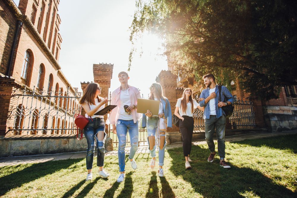 A,Group,Of,Students,On,Campus.,Two,Guys,And,Three