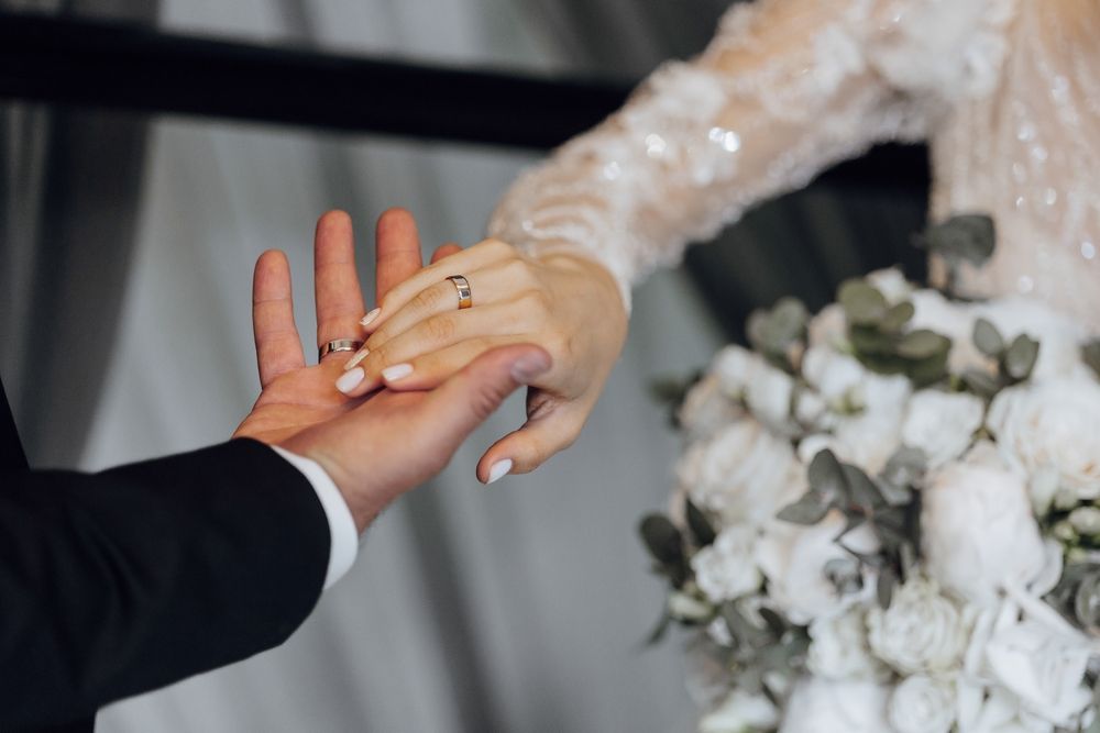 A,Bride,And,Groom,Are,Holding,Hands,,With,The,Bride