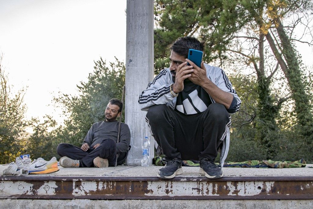 Refugees And Migrants At The Greek Borders
Asylum seekers as seen at Idomeni railway station, a few meters before the borderline between Greece and Northern Macedonia as seen resting and eating. They wait and form groups to cross the borders in the mountains and reach other European countries like Germany, France, Sweden etc via the Balkan route.  Refugees and migrants arrive at the train station from Turkey or Thessaloniki after a long multi-day journey on foot following marked routes in social media or the rails and highway but others via smugglers paying sometimes 2500 euro to smugglers to move them from Turkey here. Some of them complained for pushbacks from the N. Macedonian police after treating them violently and beating them. The station and the fenced part of the borders were guarded by Greek police and European Frontex forces. Most of the group were from Afghanistan, some from Syria, Iraq, Palestine, Pakistan, and Morocco. The flows of people arriving from Turkey are increasing every day as the refugee and migrant crisis is still ongoing. Eidomeni, Greece on October 2022  (Photo by Nicolas Economou/NurPhoto) (Photo by Nicolas Economou / NurPhoto / NurPhoto via AFP)