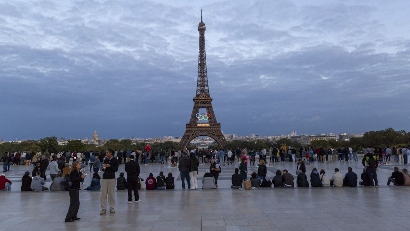 A general view of tourists on Trocadero with the Eiffel Tower and the Olympic rings in Paris, France, on September 15, 2024. Paris Mayor Anne Hidalgo advocates for keeping a version of the Olympic rings on the Eiffel Tower, while Gustave Eiffel's descendants oppose the idea, arguing that the tower should not become a permanent billboard. (Photo by Luis Boza/NurPhoto via Getty Images) (Photo by Luis Boza/NurPhoto) (Photo by Luis Boza / NurPhoto / NurPhoto via AFP)