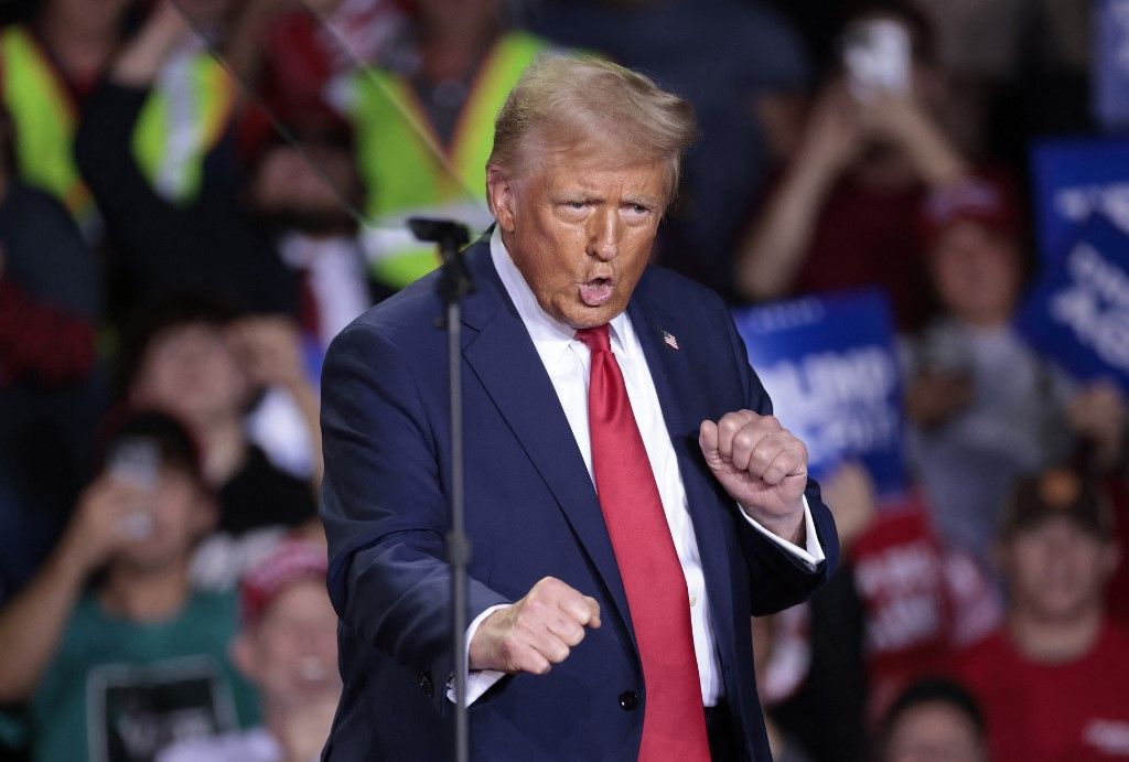 Former US President and Republican presidential candidate Donald Trump dances as he arrives to speak during his final campaign rally at the Van Andel Arena in Grand Rapids, Michigan, on the early morning of November 5, 2024. (Photo by JEFF KOWALSKY / AFP)