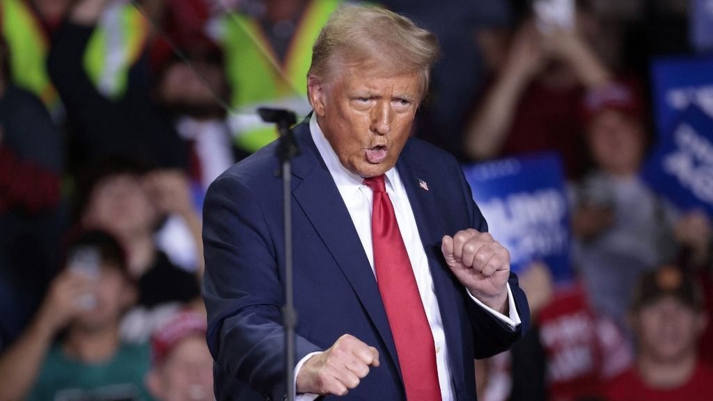 Former US President and Republican presidential candidate Donald Trump dances as he arrives to speak during his final campaign rally at the Van Andel Arena in Grand Rapids, Michigan, on the early morning of November 5, 2024. (Photo by JEFF KOWALSKY / AFP)