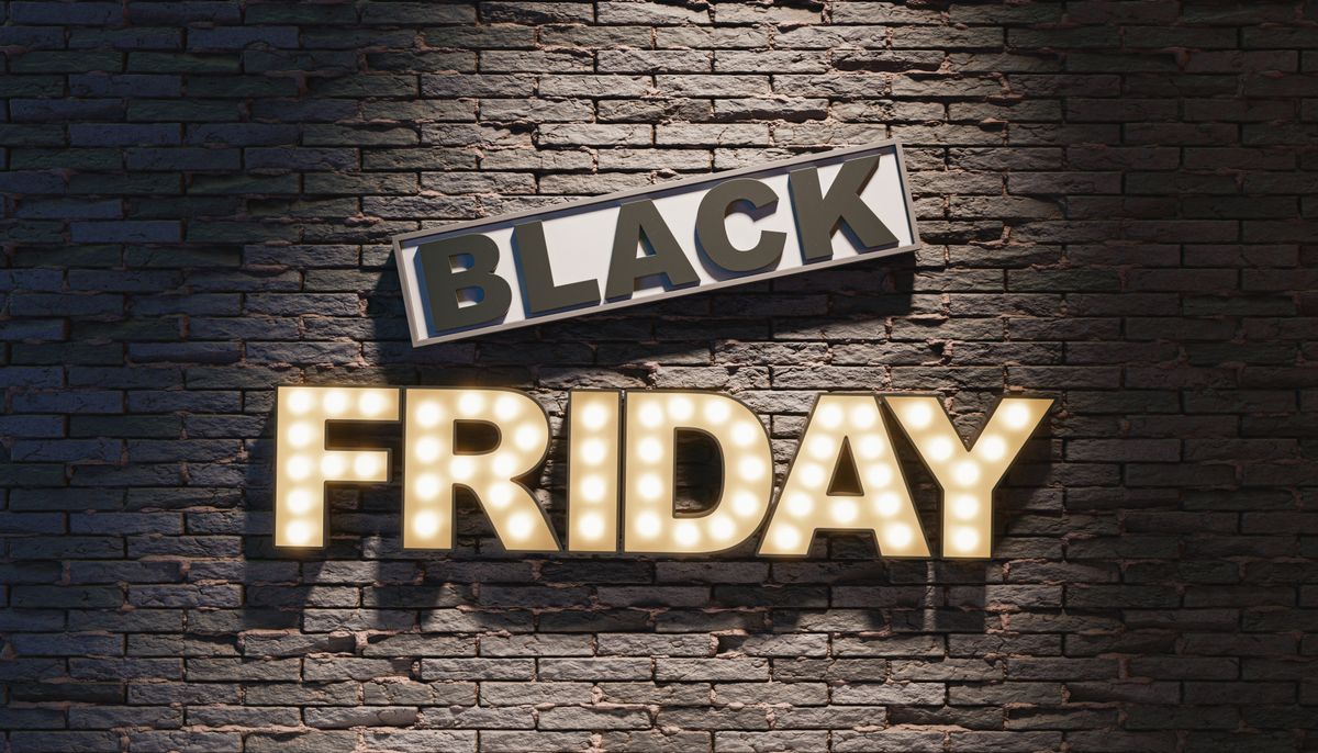 Black Friday signboard hanging on gray wall