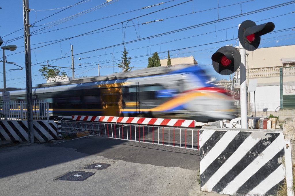 Trenitalia Regional Train In Motion At Railroad Crossing