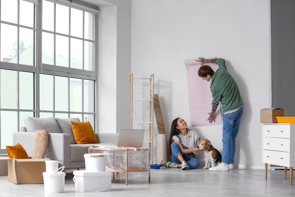 Young,Couple,With,Beagle,Dog,Wallpapering,During,Repair,In,Their