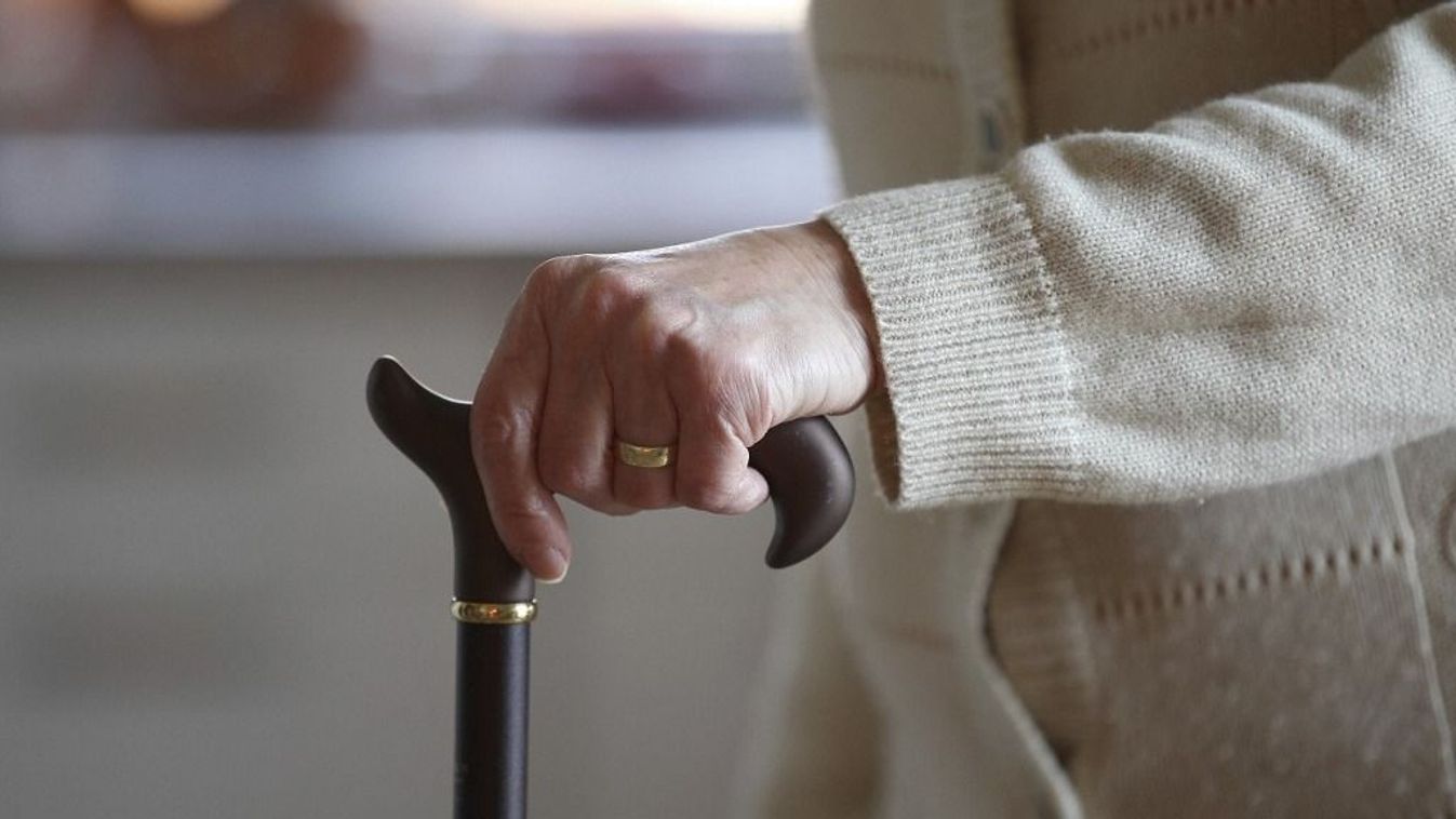 Topic picture - pensioner, senior citizen, elderly woman with rollator, walking aid and walking stick, stick and corona mask, disposable protective mask in old people's home, old people's home, assisted living, idősgondozás