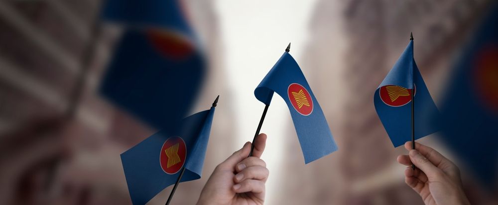 A,Group,Of,People,Holding,Small,Flags,Of,The,Asean