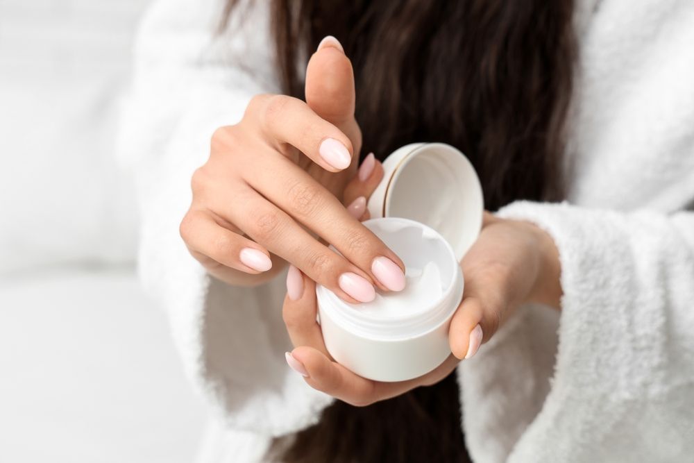 Woman,In,Bathrobe,With,Jar,Of,Natural,Cream,,Closeup