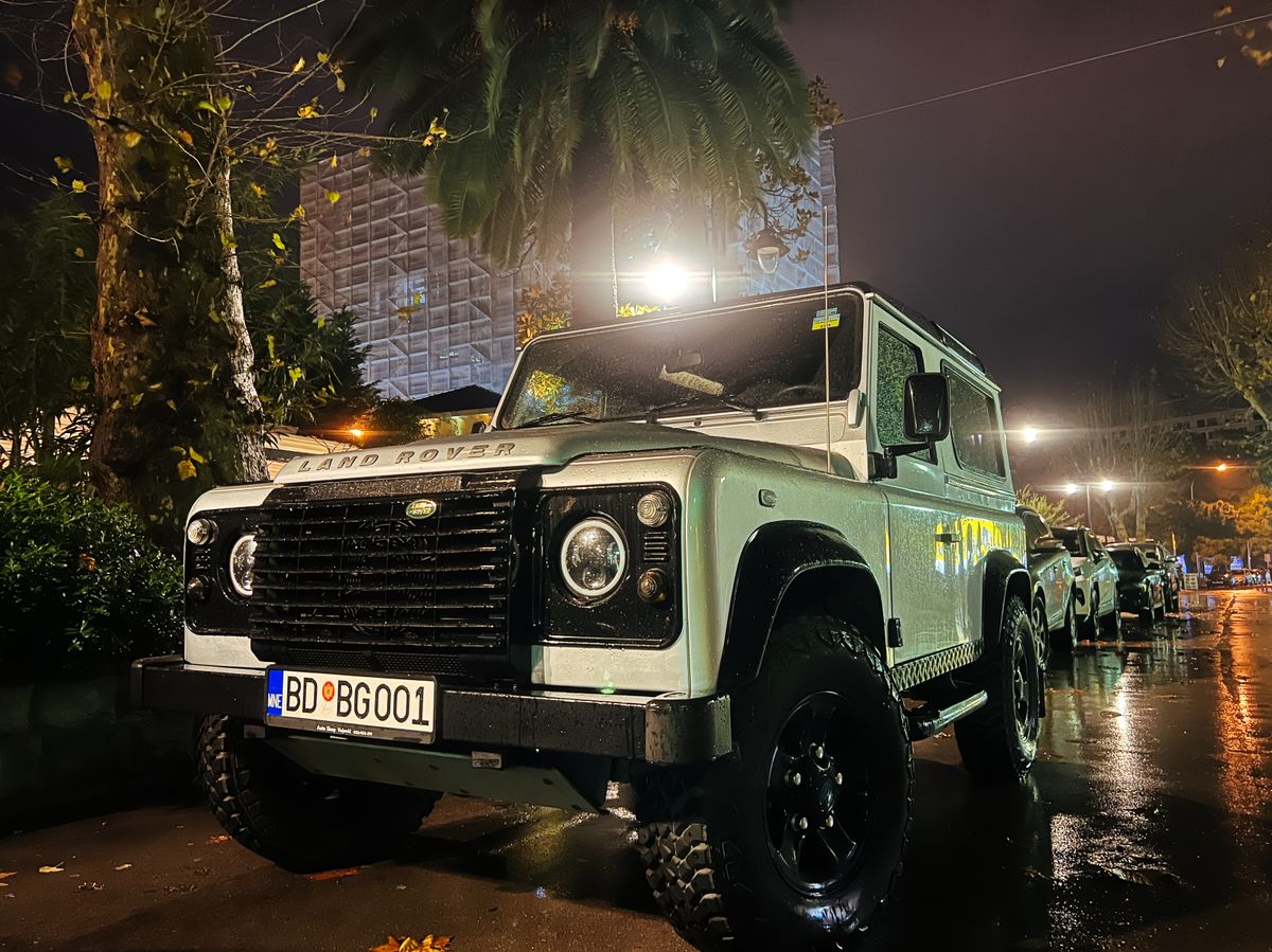 Budva, Montenegro - 25 december 2022: White SUV stands in the parking lot under a street lamp. Logo: Land Rover
suv