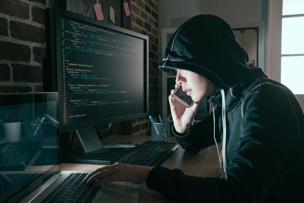 Professional,Hacker,Woman,Hidden,Face,Using,Mobile,Cell,Phone,Talking