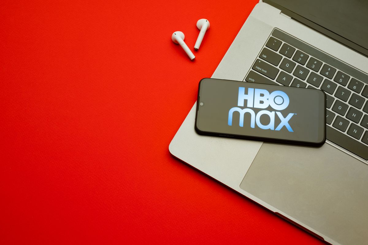 HBO Max logo on smartphone screen on red background.