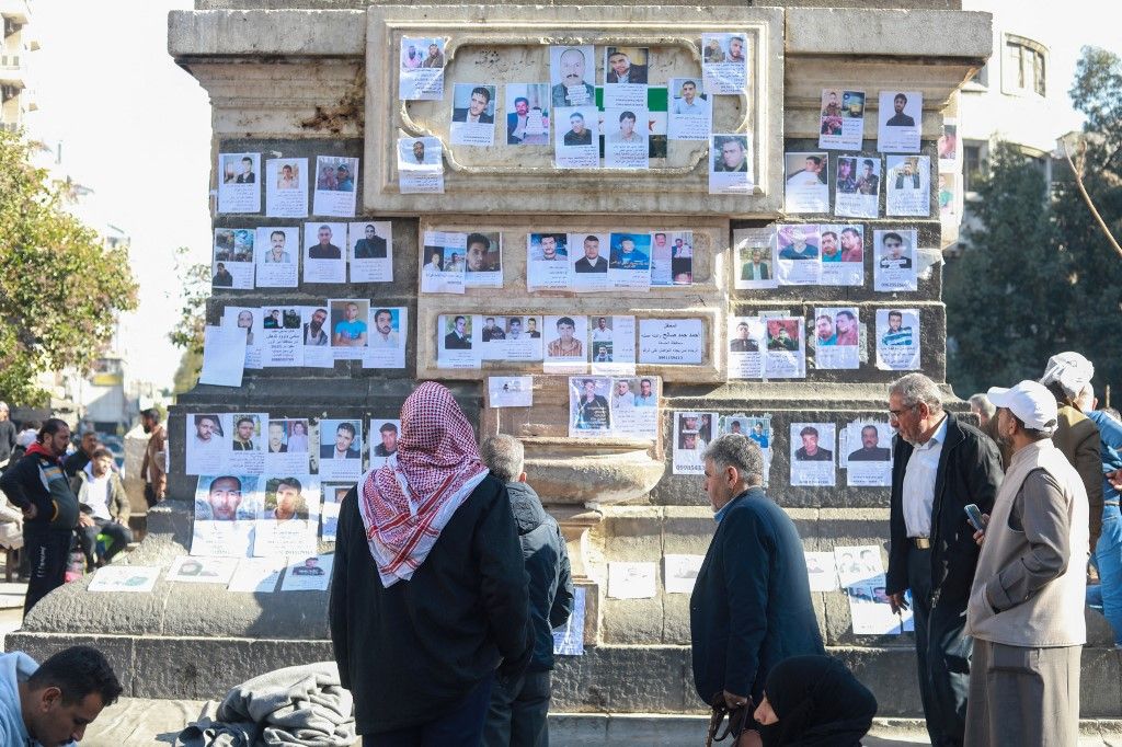 Syrians search for their relatives with posters in Damascus