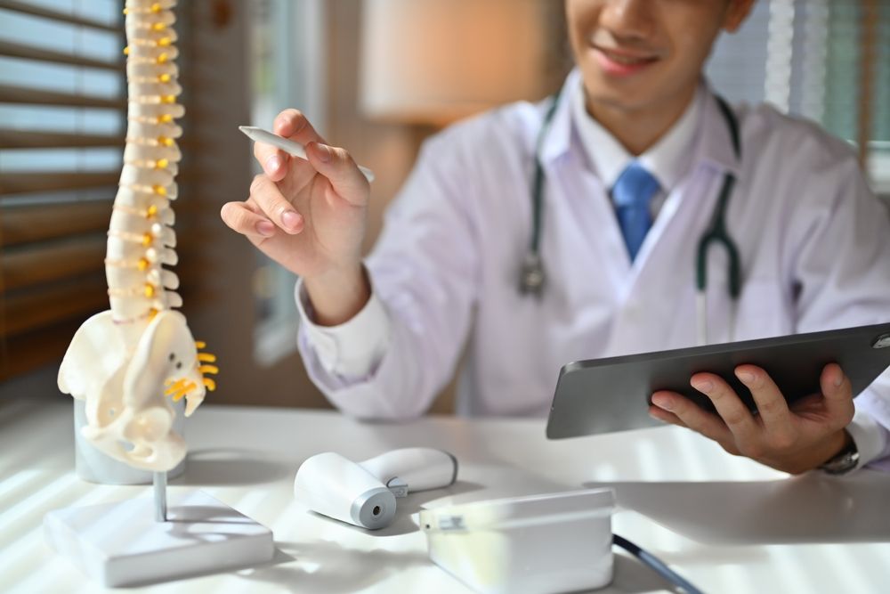 Orthopedists,Holding,Digital,Tablet,And,Pointing,At,Model.,Concept,Of