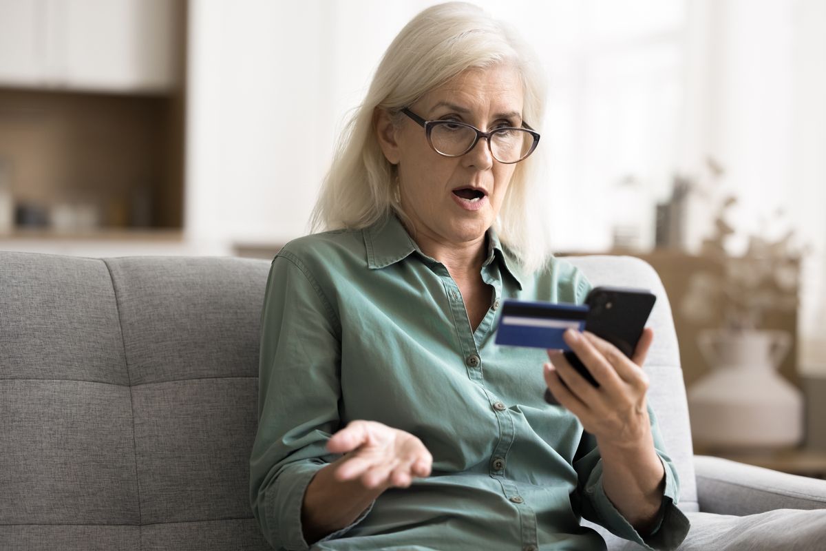 Shocked,Woman,Holding,Card,And,Smartphone,,Experiencing,Failed,Transaction,While