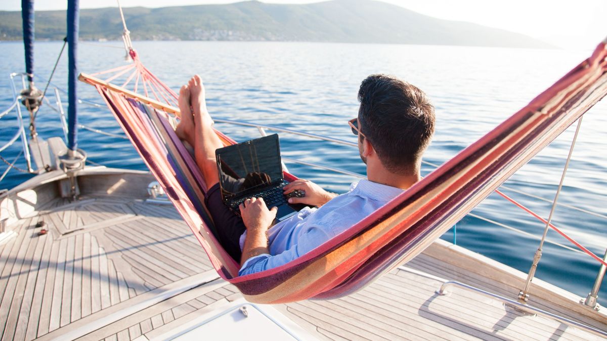 Working,In,Sea,Traveling.,Man,With,Laptop,In,Beach,Hammock.