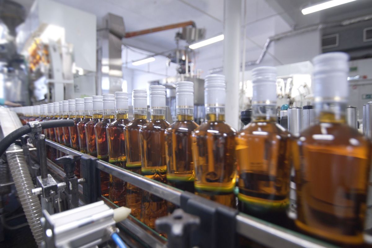Glass,Bottles,Filled,With,Alcoholic,Beverages,Move,Along,Conveyor,Line